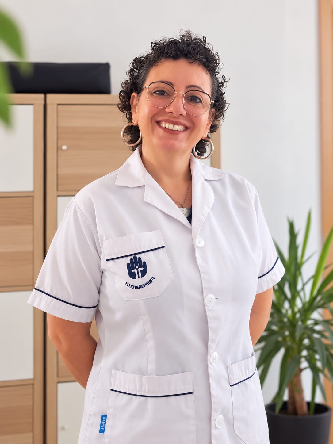 Lia Carla Rangel, de bata de fisioterapeuta, na clínica